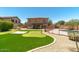 Expansive backyard featuring a pool, putting green, and an outdoor entertaining area at 1250 E Canyon Creek Dr, Gilbert, AZ 85295