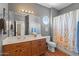 Bathroom featuring a vanity with sink, toilet, and shower-tub combo at 1250 E Canyon Creek Dr, Gilbert, AZ 85295
