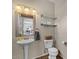 Charming powder room with pedestal sink and decorative mirror with decorative shelves at 1250 E Canyon Creek Dr, Gilbert, AZ 85295