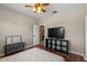 Bedroom featuring bed, television, and adjacent access to a bathroom at 1250 E Canyon Creek Dr, Gilbert, AZ 85295