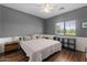 Cozy bedroom featuring a ceiling fan, wood floors, and bright natural light from the window at 1250 E Canyon Creek Dr, Gilbert, AZ 85295