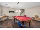 Well-lit game room with a pool table, featuring a bright and airy ambiance and cozy seating area at 1250 E Canyon Creek Dr, Gilbert, AZ 85295