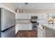 Contemporary kitchen featuring white cabinetry, stainless steel appliances, and a granite countertop island with a sink at 1250 E Canyon Creek Dr, Gilbert, AZ 85295