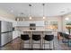 Modern kitchen with white cabinets, stainless steel appliances, and a breakfast bar with counter seating at 1250 E Canyon Creek Dr, Gilbert, AZ 85295