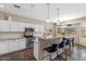 Bright and airy kitchen featuring white cabinetry, stainless steel appliances, and a spacious island with bar stools at 1250 E Canyon Creek Dr, Gilbert, AZ 85295