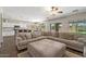 Open-concept living room with a large sectional sofa, seamlessly connected to the kitchen and dining area at 1250 E Canyon Creek Dr, Gilbert, AZ 85295