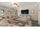 Comfortable living room with plush sofas, large windows, and a TV, perfect for relaxing and entertaining at 1250 E Canyon Creek Dr, Gilbert, AZ 85295
