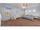 Spacious main bedroom features a ceiling fan, neutral tones, and a view to the backyard at 1250 E Canyon Creek Dr, Gilbert, AZ 85295
