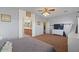 Large main bedroom features ensuite bathroom, ceiling fan, dresser and view to the backyard at 1250 E Canyon Creek Dr, Gilbert, AZ 85295