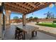 Inviting covered patio with a dining area, offering a relaxing space overlooking the backyard at 1250 E Canyon Creek Dr, Gilbert, AZ 85295
