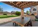 Charming covered patio with wood beams and an outdoor kitchen, perfect for entertaining at 1250 E Canyon Creek Dr, Gilbert, AZ 85295