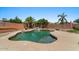Private backyard oasis with a freeform pool, lush landscaping, and a serene waterfall feature at 1250 E Canyon Creek Dr, Gilbert, AZ 85295