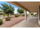 Relaxing covered back patio with ample room for seating, surrounded by trees and low maintenance desert landscaping at 13414 W San Pablo Dr, Sun City West, AZ 85375