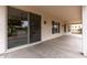 Inviting covered back patio with a sliding glass door entry, offering views of the landscaped backyard at 13414 W San Pablo Dr, Sun City West, AZ 85375