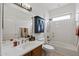 Bathroom features a vanity and sink, cabinet, mirror, toilet, and shower-tub combo at 13414 W San Pablo Dr, Sun City West, AZ 85375
