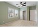 Bedroom features neutral carpet, bright windows with plantation shutters, and access to a closet at 13414 W San Pablo Dr, Sun City West, AZ 85375