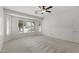 Bright bedroom boasts large windows with plantation shutters and neutral carpet at 13414 W San Pablo Dr, Sun City West, AZ 85375