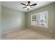 Bedroom features neutral carpet, bright windows with plantation shutters, and a ceiling fan at 13414 W San Pablo Dr, Sun City West, AZ 85375