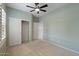 Neutral bedroom features carpet, a ceiling fan, closet and access to the rest of the home at 13414 W San Pablo Dr, Sun City West, AZ 85375