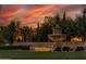 Dramatic sunset view of the Corte Bella fountain and entrance, showcasing the community's beauty at 13414 W San Pablo Dr, Sun City West, AZ 85375