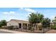 Charming single-story home with desert landscaping and a black metal fence surrounding the well-manicured front yard at 13414 W San Pablo Dr, Sun City West, AZ 85375