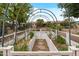 Close up view of a beautiful raised garden bed with a decorative metal arch and stepping stone path at 13414 W San Pablo Dr, Sun City West, AZ 85375