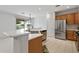 Bright kitchen featuring stainless steel appliances, light countertops, and wood cabinetry at 13414 W San Pablo Dr, Sun City West, AZ 85375