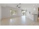 Spacious living area with tile floors, ceiling fan, and a view of the outdoor area through sliding glass doors at 13414 W San Pablo Dr, Sun City West, AZ 85375