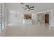 Large, open living space featuring tile floors, a ceiling fan, and a kitchen bar top at 13414 W San Pablo Dr, Sun City West, AZ 85375