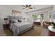 Serene main bedroom featuring a ceiling fan, neutral tones, and natural light at 13414 W San Pablo Dr, Sun City West, AZ 85375