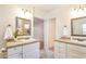 Bathroom featuring dual vanities with framed mirrors and overhead sconce lighting at 1413 W 7Th Pl, Tempe, AZ 85281
