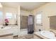 Bright bathroom featuring double sinks, a shower/tub combination, and neutral tile at 1413 W 7Th Pl, Tempe, AZ 85281