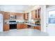 Well-lit kitchen equipped with wood cabinets, gray countertops, and modern stainless-steel appliances at 1413 W 7Th Pl, Tempe, AZ 85281