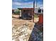 View of the dilapidated shed surrounded by debris, presenting significant repair or removal requirements at 1416 E Southern Ave, Apache Junction, AZ 85119