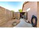 View of backyard with a concrete path, shed with yard tools and a garden hose at 1492 E Westchester Dr, Chandler, AZ 85249