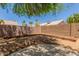 Backyard featuring rock details, desert landscaping and tall block fence at 1492 E Westchester Dr, Chandler, AZ 85249