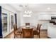 Light dining room boasts an ornate chandelier and a view of the kitchen at 1492 E Westchester Dr, Chandler, AZ 85249