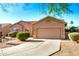 Home exterior showcasing the low maintenance front yard, tile roof and two-car garage at 1492 E Westchester Dr, Chandler, AZ 85249