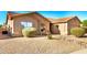 View of the property featuring a xeriscaped front yard and small patio seating with desert landscaping at 1492 E Westchester Dr, Chandler, AZ 85249