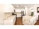 Open kitchen with an island, stainless appliances, granite countertops and white cabinets at 1492 E Westchester Dr, Chandler, AZ 85249