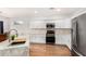 Well-equipped kitchen featuring granite countertops, white cabinetry, and stainless steel appliances at 1492 E Westchester Dr, Chandler, AZ 85249
