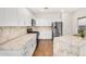 Contemporary kitchen with stainless steel appliances, granite countertops, white cabinetry, and wood flooring at 1492 E Westchester Dr, Chandler, AZ 85249