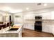 Bright kitchen with white cabinets, granite countertops, an island and stainless appliances at 1492 E Westchester Dr, Chandler, AZ 85249