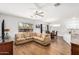 Inviting living room with a ceiling fan, wood flooring, and views of the dining area and kitchen at 1492 E Westchester Dr, Chandler, AZ 85249