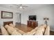 Cozy living room with laminate floors, ceiling fan, and neutral paint at 1492 E Westchester Dr, Chandler, AZ 85249