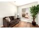 Relaxing living room with decorative sofa, wood floor and a large window at 1492 E Westchester Dr, Chandler, AZ 85249