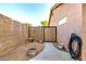 Side yard with rock landscaping, concrete walkway and wood gate to backyard at 1492 E Westchester Dr, Chandler, AZ 85249