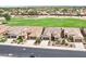 An aerial view showing homes with manicured lawns and mature trees and community greenbelts at 16165 W Vale Dr, Goodyear, AZ 85395