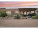 A cozy backyard with a covered patio, desert plants, and privacy at 16165 W Vale Dr, Goodyear, AZ 85395