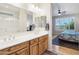 Bathroom with dual sinks and vanity, plus bedroom entrance at 16165 W Vale Dr, Goodyear, AZ 85395